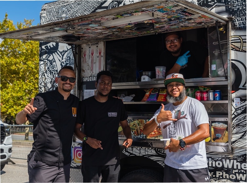 Food truck vendors giving a thumbs up